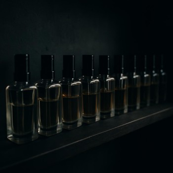 Perfume test bottles stored on a dark shelf away from light