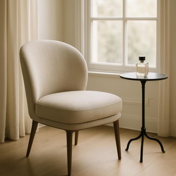 Single chair by a window with a small table and perfume bottle