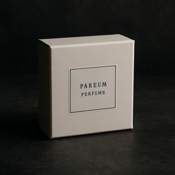 Closed perfume box with a subtle label on a table