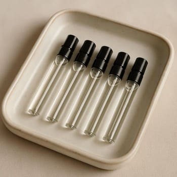 Set of slim perfume discovery vials arranged on a ceramic tray